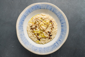 risotto four cheeses on grey concrete table top view