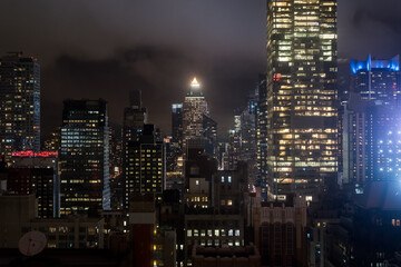 Manhattan interior view from a high floor at night in NYC - Powered by Adobe