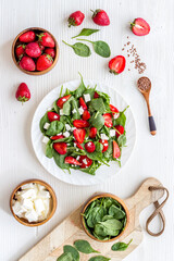 Spinach salad with strawberry and goat cheese, top view