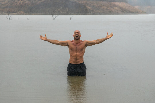 Screaming shirtless man in river