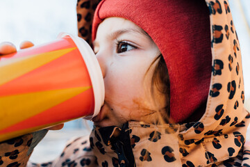 Girl drinking hot beverage on winter day