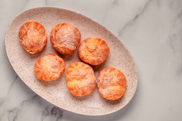 Homemade profiteroles with powdered sugar.