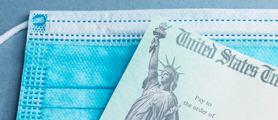 A tax return stimulus check with a blue face mask