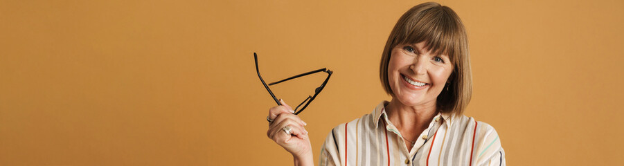 Senior woman smiling while posing with wearing eyeglasses