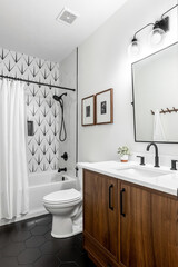 Modern bathroom white tub, walnut vanity, matte black faucets, white walls, mid century...