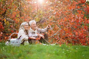 Happy senior woman and man in park