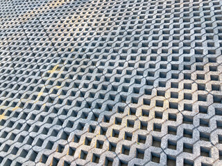 gray color stone brick block floor tile with green grass and sand as background or texture.