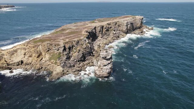 Ilheu da Papoa, rocky peninsula and headland with jagged cliffs in Peniche, Portugal