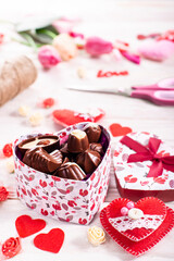 Chokolate box in shape of heart on white wooden table valentine background low angle view