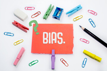 BIAS Text is written on Set of colorful paper clips with white copy space background