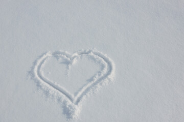 Heart painted on white fluffy snow. Valentine's Day concept. Card with copy space.