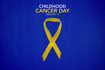 Childhood Cancer Awareness Yellow Ribbon on blue background with copy space. Childhood Cancer Day...