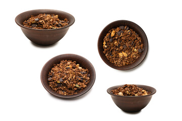 Chocolate granola cereal with nuts in a bowl background.
