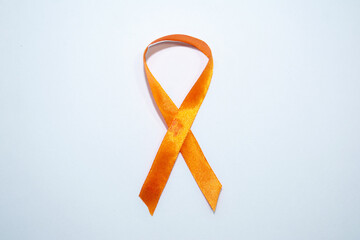 Orange ribbon is a symbol of Animal Abuse, leukemia awareness, kidney cancer association, multiple sclerosis. white background with copy space