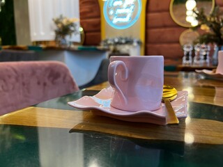 pink small cup with golden spoon