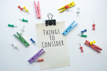 Text sign showing Things to Consider with copy space, stationery items in white background 