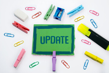 Text sign with Update written paper clips, clips stationary in background.