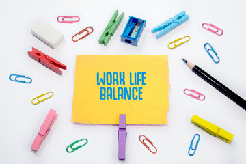Text sign showing Work-Life Balance on Set of colorful paper clips with white copy space background