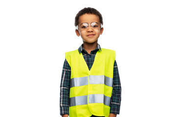 building, construction and profession concept - smiling little boy in goggles and yellow safety...