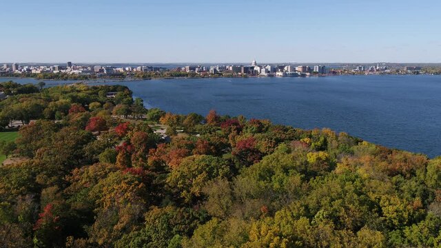 Fall Colors Trees over Olin Park Flying Towards Downtown Madison in Fall (Drone - Push In)