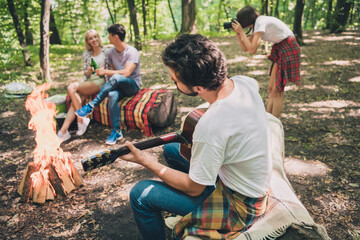 Photo of four friends guy play acoustic guitar couple enjoy beer lady make photo wear casual outfit nature woods outdoors