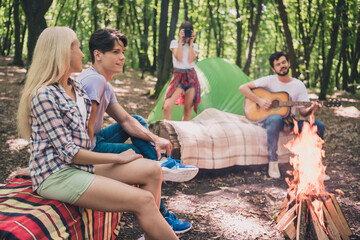 Photo of best friends happy positive smile cam-fire play guitar music song camp forest expedition rest outdoors