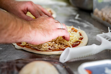 Closeup hand of chef baker making pizza at kitchen. The process of making pizza. cooking italian pizza