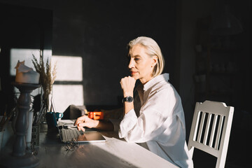 Female entrepreneur working at table at art studio