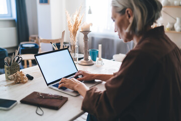 Female entrepreneur working at table at art studio
