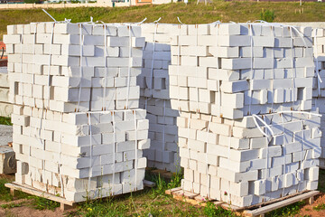 Smooth stacks of bricks in a package. Preparation for the construction of a house. Building materials.