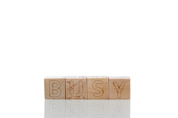 Wooden cubes with letters busy on a white background