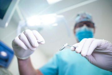 Dentist handling dental tools in patient's view