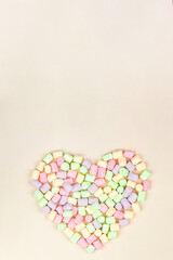 Candy sweets. Marshmallow heart shape on pink background. Valentine's day concept. Top view, sweets and candy concept.