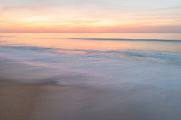 Fototapeta na wymiar Movement of the waves in the Alentejo sunset
