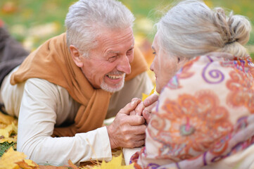 Happy senior woman and man in park