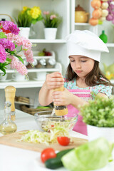 Portrait of cute girl preparing delicious fresh salad