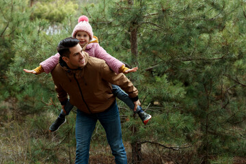 Man and his daughter spending time together in forest