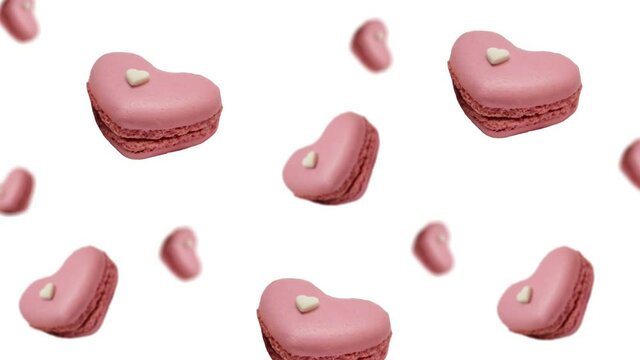 A stream of many different diameters French macaroon cookies with raspberry and strawberry on a white color background. The Concept of St. Valentine's, weddings, birthday days and other holiday 
