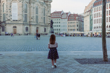 girl looks at the Frauenkirche Dresden Church of our lady