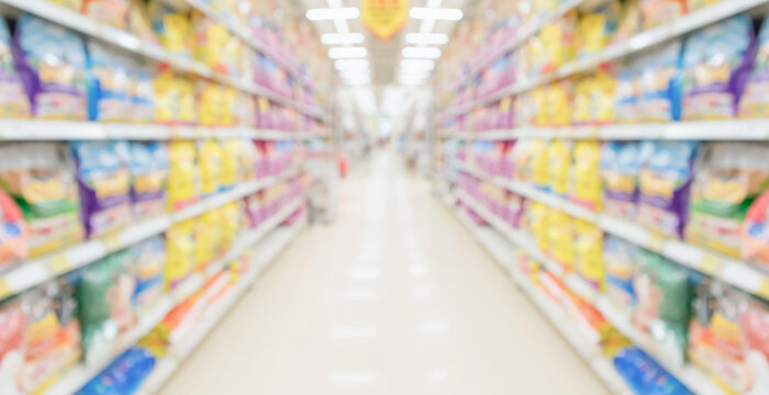 Abstract blur supermarket discount store aisle and product shelves interior defocused background
