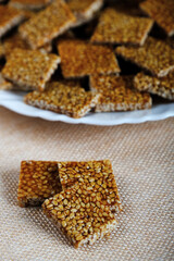 Makar sankranti special items Tilgul, Til ke laddu, Chikki all sweet items made with white sesame seeds and jaggery. Winter special indian food healthy seasonal.