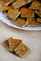 Makar sankranti special items Tilgul, Til ke laddu, Chikki all sweet items made with white sesame seeds and jaggery. Winter special indian food healthy seasonal.