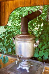 Traditional Russian samovar with a pipe on the summer veranda.
