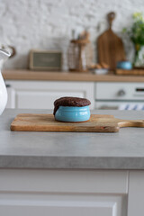 Chocolate mugcake on wooden cookingboard. Vertical image. Copyspace