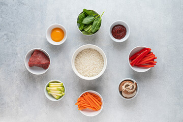 Set of ingredients for cooking bibimbap, traditional korean dish, top view