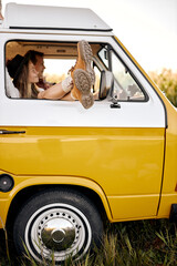 legs peeping out of van's window. alternative way of travel and enjoy the world. discover new...