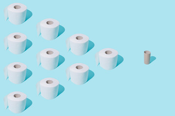 Toilet paper rolls on blue pastel background. Stomach upset. Toilet paper rolls pattern. Global Corona virus pandemic. Isolation mood. WC minimalism. Flat lay. Bathroom minimal concept.