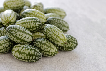 Cucamelon (Melothria scabra) vegetable pile. Organic mouse melon fruits heap.