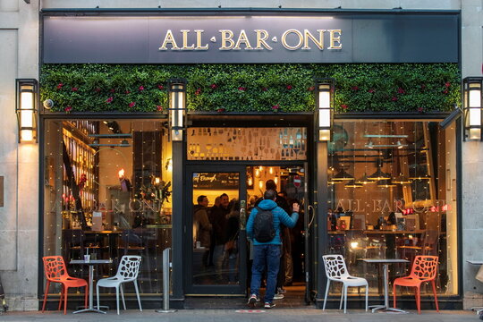 A person enters a branch of All Bar One in London