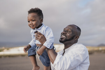 African father holding little son outdoor - Family love - Black man enjoy day outdoor with with...